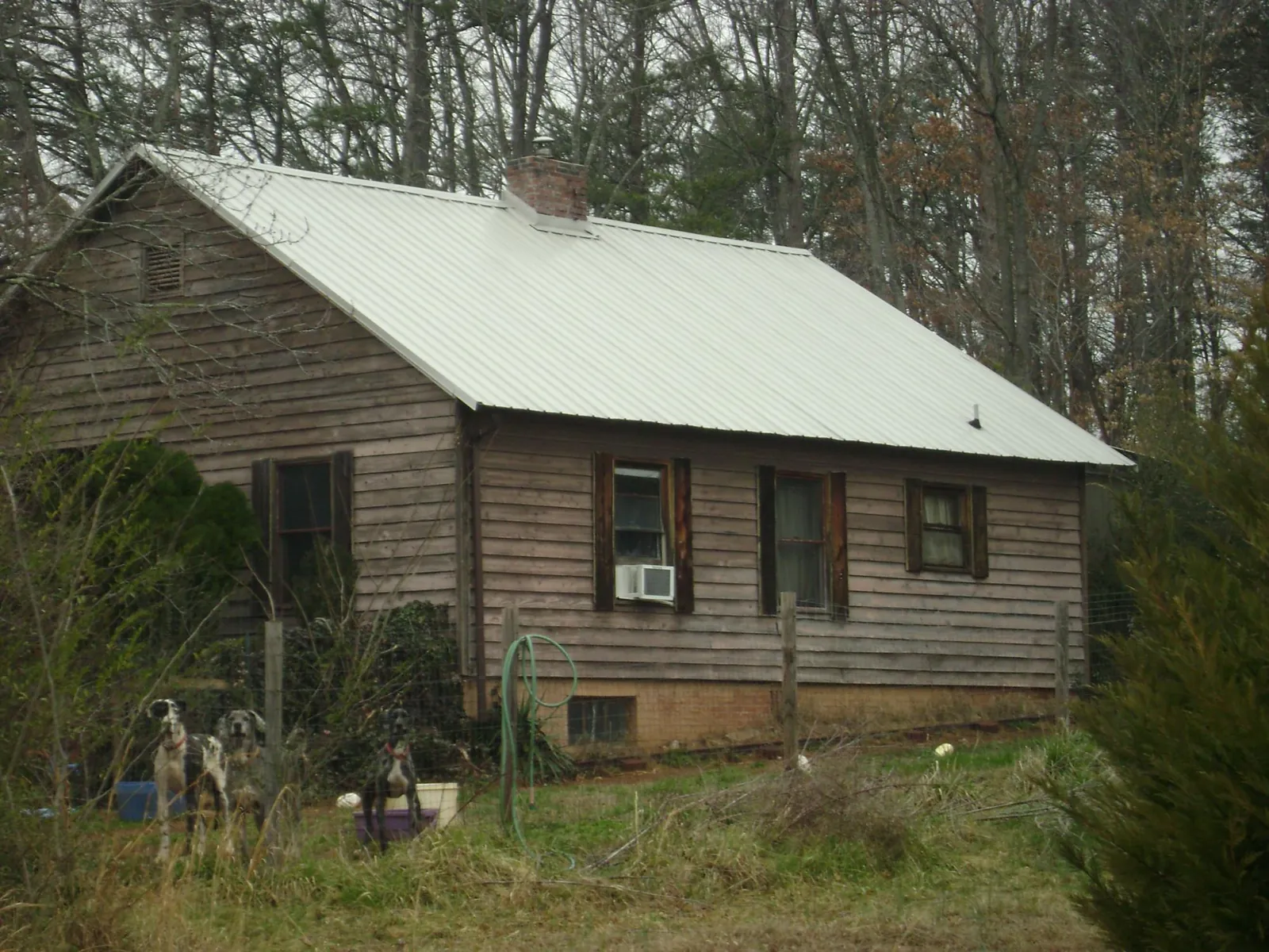 White metal roof on an old wood sided farmhouse, from a Metal Roof Installation job in Colrain